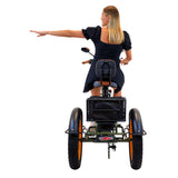 Image of a woman gracefully navigating a corner on the 3SCORE Hunter Edition Dual Battery foldable etrike with fat tires, extending her arm to signal her turn. This cargo e-tricycle is equipped for transporting goods, making it an ideal choice for urban deliveries and errands. Experience the versatility and convenience of this electric cargo tricycle, designed to meet your transportation needs with ease
